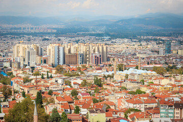 Obraz premium Aerial view of Bursa city. Town landscape with cloudy sky. Bursa is touristic destination in Turkey.