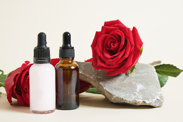 roses two different dropper bottles with serum and cosmetic oil.