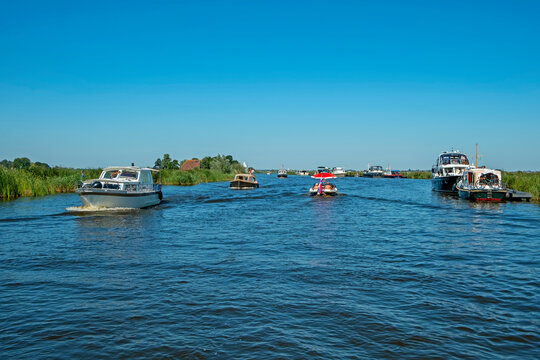 Cruising on frisian canals on a beautiful summer day in the Netherlands