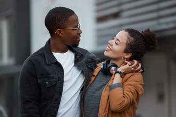 Young couple walking in the city on the street, holding hands and in love. Dating, love and black woman with black man in multicultural relationship, smiling and hugging taking walk in urban town