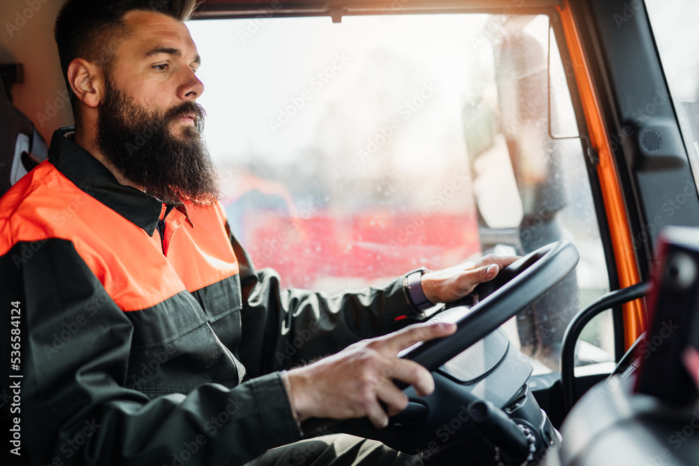 Sticker young garbage removal worker driving a waste truck