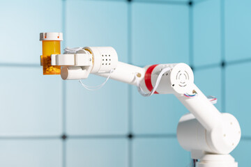 Robot arm with a pills in bottle in the laboratory. The concept of artificial intelligence in pharmaceuticals