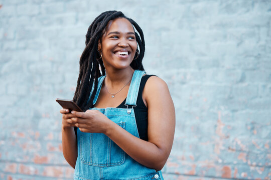 Smartphone, digital networking and black woman with mobile app, social media post or 5g internet outdoor with mock up blue wall. Happy african gen z girl typing on her cellphone for youth online blog