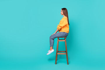 Side profile full length photo of young adorable pretty woman sitting chair look empty space relax...