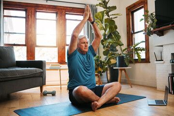 Yoga, meditation and wellness with a zen man following an online class for fitness, exercise and workout at home. Senior, retirement and health with an elderly male pensioner exercising in his house