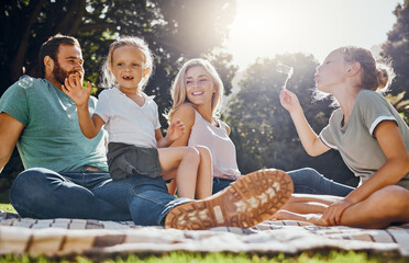 Happy family, picnic and summer, fun in park with children and parents bonding and playing on...