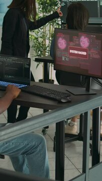 Vertical video: Company developer writing code encounters system failure, parsing algorithm and having computer hacked. Database coder having unexpected compiling error in software development office.
