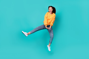 Fototapeta na wymiar Full body size photo of young adorable nice lady wear yellow shirt denim jeans summer outfit relax weekend dance air fly isolated on aquamarine color background