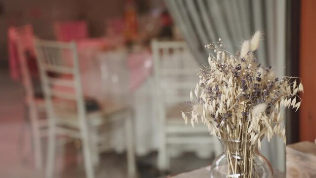 Ecological bouquet of dried oats, lavender and lagurus in glass vase.