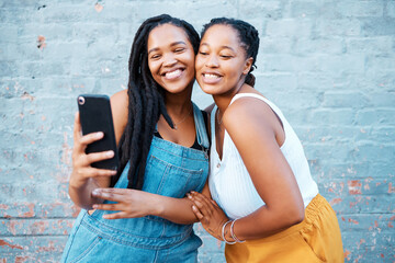 Black women, friends and selfie while smiling and happy outside against city or urban wall and...
