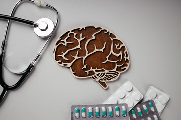 A stethoscope and brain with pills. Top view. Awareness of Alzheimer's, Parkinson's disease,...