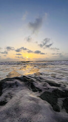 sunset at sea, white waves and variety of colors