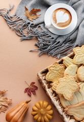 Cup of coffee, cookies on tray, yellow leaves.