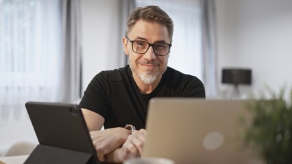 Man working with laptop in home office