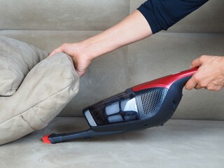 Woman with hand vacuum cleaner
