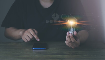 man holding a light bulb Concept ideas with innovation and inspiration.