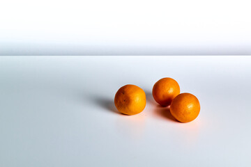 Oranges lie on a white table