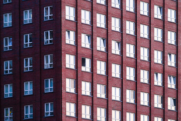 A lot of windows on a skyscraper building. Urban textures and backgrounds. Modern architecture and design. Building details.