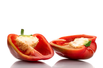 Two halves of red sweet pepper, close-up, isolated on white.