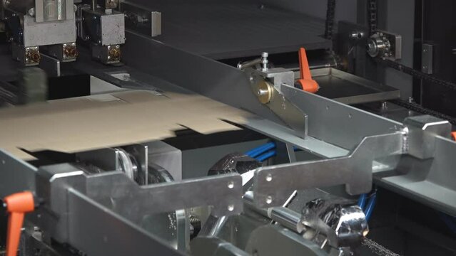 Machines for the production of paper containers or packaging, for further use in the food industry.