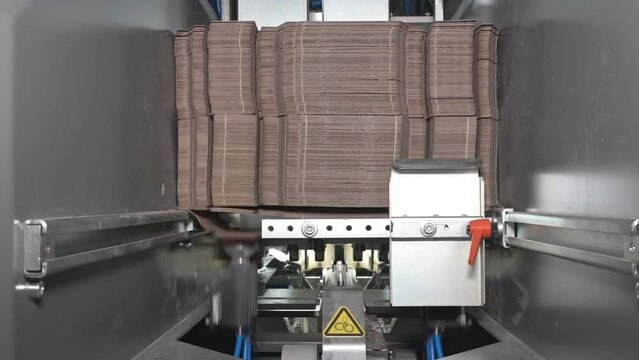 Machines for the production of paper containers or packaging, for further use in the food industry.