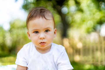 Cute funny kid with blur background. Portrait of happy little boy.