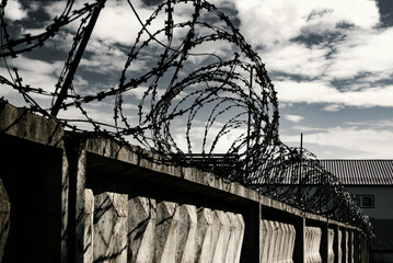Prison. Prison wall with barbed wire. Law and justice - obrazy, fototapety, plakaty