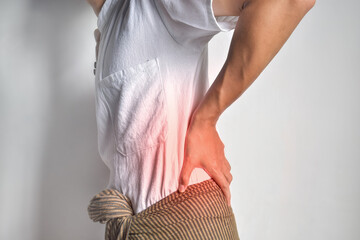 Asian man suffering from back and loin pain. It can be caused by renal stone.