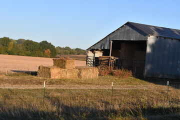Hay Bales by a Metal Barn