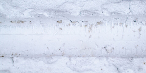 The track of a car wheel in the snow