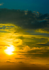 Beautiful sky with bright sunset (sunrise) and clouds. Vertical photo.