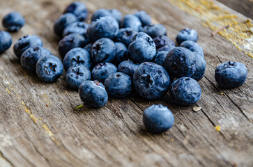 Autumn harvest of blueberries in the garden, lie on an old board.