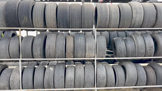 Sale of used tires. People use worn tires. Group of used tires for tire repair workshops. 