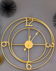 Wall clock and decorative elements close-up on a gray wall background