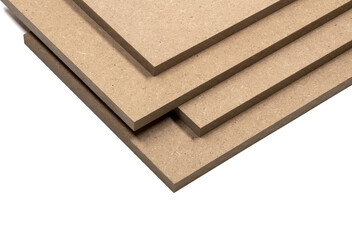 Four boards of raw mdf with clear and precise edges, arranged in a pile.