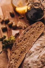 Fotobehang Vertical shot of cut bread on a wooden board © Nacho Ramirez/Wirestock Creators