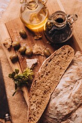 Vertical shot of cut bread on a wooden board