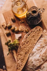 Fotobehang Vertical shot of cut bread on a wooden board © Nacho Ramirez/Wirestock Creators
