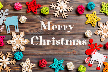 Merry Christmas text. Top view of Christmas decorations and toys on wooden background. Copy space. Empty place for your design. New Year concept
