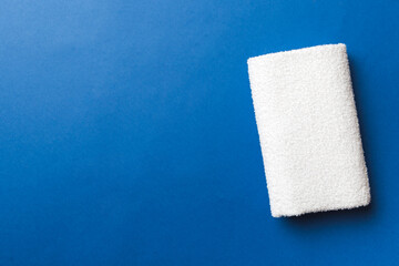 Top view of white towels with copy space on colored background