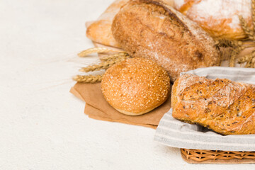 Homemade natural breads. Different kinds of fresh bread as background, perspective view with copy space