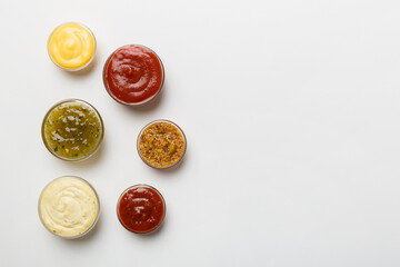 Different types of sauces in bowls on a colored Board . Top view. various sauces copy space