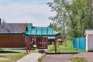 Prayer drums on footpath in residential sector. Ivolginsky Datsan, centre of Buddhism in Russia.