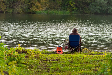 Fototapeta na wymiar a fisherman on the background of a pond