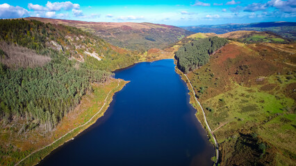 Fototapeta premium Llyn Geirionydd lies in a valley in North Wales where the northern edge of the Gwydyr Forest meets the lower slopes of the Carneddau mountains. The lake is almost a mile long and covers an area of 45 