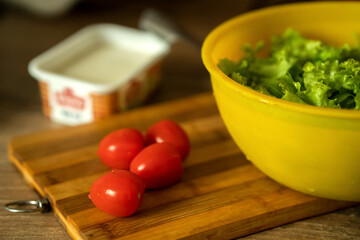 homemade light salad of lettuce, tomatoes, feta cheese and canned salmon. home cooking.