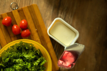 homemade light salad of lettuce, tomatoes, feta cheese and canned salmon. home cooking.