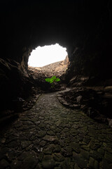 the light at the end of the tunnel: exit from Cueva de Los Verdes, Lanzarote, Canary Islands