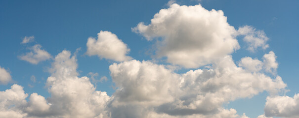 Naklejka na ściany i meble Large cluster of clouds against the blue sky