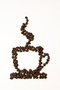 Hot espresso or cappuccino from beans. Image of a cup of coffee from coffee beans on a white background.